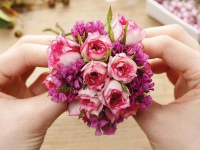 Hands creating bouquet